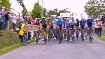 Momento en el que Tony Martin choca con un cartel de una espectadora y que provocó una grave caída en el pelotón en la primera etapa del Tour de Francia, con Marc Soler y Jasha Sütterlin como grandes afectados.