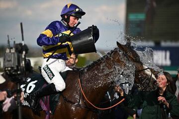 Jockey Derek Fox cools off his mount as he returns on Corach Rambler winner of the Grand National Steeple Chase on the final day the final day of the Grand National Festival horse race meeting at Aintree Racecourse in Liverpool, north-west England, on April 15, 2023. (Photo by Oli SCARFF / AFP) (Photo by OLI SCARFF/AFP via Getty Images)