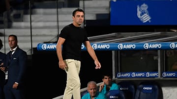 Barcelona's Spanish coach Xavi walks on the sideline during the Spanish League football match between Real Sociedad and FC Barcelona at the Anoeta stadium in San Sebastian on August 21, 2022. (Photo by Ander GILLENEA / AFP)