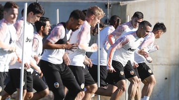 Los jugadores del Valencia realizan ejercicios durante el entrenamiento de ayer.