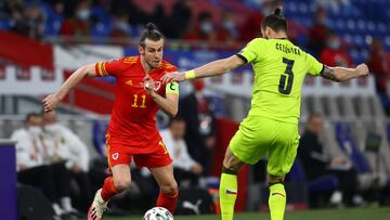 CARDIFF, WALES - MARCH 30: Gareth Bale of Wales on the ball whilst under pressure from Ondrej Celustka of Czech Republic during the FIFA World Cup 2022 Qatar qualifying match between Wales and Czech Republic on March 30, 2021 in Cardiff, Wales. Sporting s