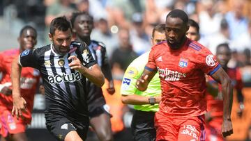 Angers&#039; French midfielder Thomas Mangani (L) fights for the ball with Lyon&#039;s French forward Moussa Dembele (R) during the French L1 football match between Angers SCO and Olympique Lyonnais, at the Raymond-Kopa Stadium, in Angers, western France,