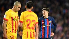 Barcelona's Spanish midfielder Gavi (R) reacts grimacing during the Spanish league football match between FC Barcelona and Girona FC at the Camp Nou stadium in Barcelona on April 10, 2023. (Photo by Pau BARRENA / AFP)