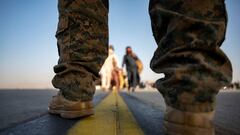 A US Marine provides security for qualified evacuees boarding a US Air Force C-17 Globemaster III in support of the noncombatant evacuation operation at Hamid Karzai International Airport in Kabul. 