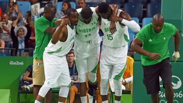 Michael Umeh y Ekene Ibekwe ayudan a salir de la cancha a Shane Lawal.