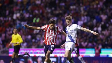 Jonathan Yael Padilla (L) of Guadalajara fights of the ball with with Facundo Waller (R) of Puebla during the 14th round match between Puebla and Guadalajara as part of the Liga BBVA MX, Torneo Apertura 2024 at Cuauhtemoc Stadium on October 25, 2024 in Puebla, Mexico.