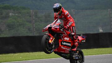 Ducati Italian rider Francesco Bagnaia celebrates after taking the pole position after the qualifying rounds ahead of the Italian MotoGP race at Mugello Circuit in Mugello, on June 10, 2023. (Photo by Filippo MONTEFORTE / AFP)