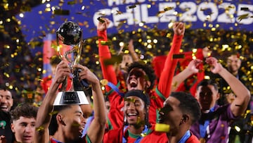 Morroco's team members celebrate with the trophy after winning the 2025 FIFA U-20 World Cup final football match between Argentina and Morocco at the National Stadium in Santiago on October 19, 2025. (Photo by Javier TORRES / AFP)