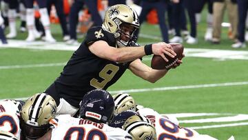 NEW ORLEANS, LOUISIANA - JANUARY 10: Drew Brees #9 of the New Orleans Saints dives in the end zone to score a one yard touchdown against the Chicago Bears during the fourth quarter in the NFC Wild Card Playoff game at Mercedes Benz Superdome on January 10