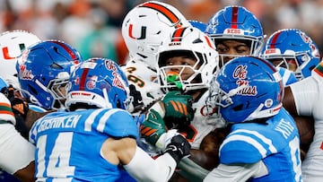 GLENDALE, ARIZONA - JANUARY 08: Charmar Brown #6 of the Miami Hurricanes carries the ball defended by the Ole Miss Rebels in the second quarter during the 2025 College Football Playoff Semifinal at the VRBO Fiesta Bowl at State Farm Stadium on January 08, 2026 in Glendale, Arizona. Ronald Martinez/Getty Images/AFP (Photo by RONALD MARTINEZ / GETTY IMAGES NORTH AMERICA / Getty Images via AFP)