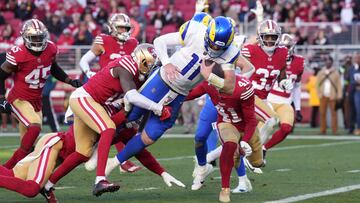Los Angeles Rams quarterback Carson Wentz (11) dives for a touchdown against San Francisco 49ers cornerback Samuel Womack III (left) and safety Tayler Hawkins (41).