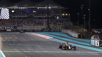 ABU DHABI, UNITED ARAB EMIRATES - DECEMBER 12: Race winner Max Verstappen of the Netherlands driving the (33) Red Bull Racing RB16B Honda takes the chequered flag during the F1 Grand Prix of Abu Dhabi at Yas Marina Circuit on December 12, 2021 in Abu Dhab