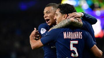 Paris Saint-Germain's French forward Kylian Mbappe (C) and Paris Saint-Germain's Brazilian defender Marquinhos celebrate their team's second goal during the French L1 football match between Paris Saint-Germain (PSG) and Olympique de Marseil