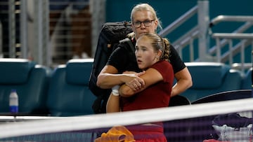 Mar 23, 2025; Miami, FL, USA; Mirra Andreeva receives treatment from aWTA trainer during an injury timeout against Amanda Anisimova (USA)(not pictured) on day six of the Miami Open at Hard Rock Stadium. Mandatory Credit: Geoff Burke-Imagn Images