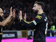 Manchester United's Cameroonian midfielder #19 Bryan Mbeumo (L) celebrates scoring the team's second goal with Manchester United's Portuguese midfielder #08 Bruno Fernandes during the English Premier League football match between Wolverhampton Wanderers and Manchester United at the Molineux stadium in Wolverhampton, central England on December 8, 2025. (Photo by Darren Staples / AFP) / RESTRICTED TO EDITORIAL USE. No use with unauthorized audio, video, data, fixture lists, club/league logos or 'live' services. Online in-match use limited to 120 images. An additional 40 images may be used in extra time. No video emulation. Social media in-match use limited to 120 images. An additional 40 images may be used in extra time. No use in betting publications, games or single club/league/player publications. /