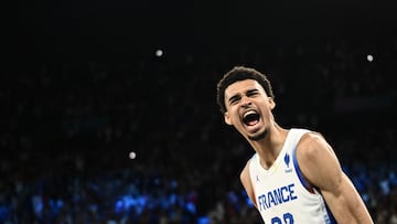 France's #32 Victor Wembanyama celebrates after France won the men's semifinal basketball match between France and Germany during the Paris 2024 Olympic Games at the Bercy Arena in Paris on August 8, 2024. (Photo by Aris MESSINIS / AFP)