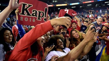 Colin Kaepernick poses for photos with fans in San Diego.