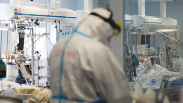 A medical worker in a protective suit treats a patient suffering from the coronavirus disease (COVID-19) in an intensive care unit at the San Filippo Neri hospital in Rome, Italy, October 29, 2020. REUTERS/Yara Nardi