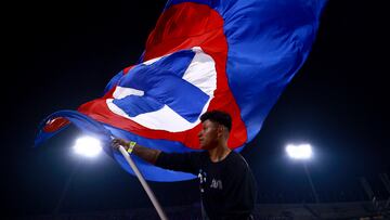 Soccer Football - Liga MX - Cruz Azul v America - Estadio Olimpico Universitario Mexico 1968, Mexico City, Mexico - October 18, 2025 A Cruz Azul fan is pictured waving a flag inside the stadium before the match REUTERS/Eloisa Sanchez