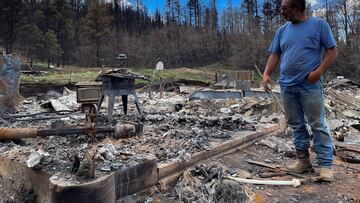Daniel Encinias stands next to the ruins of his home destroyed by the Hermits Peak Calf Canyon fire in Tierra Monte, New Mexico.