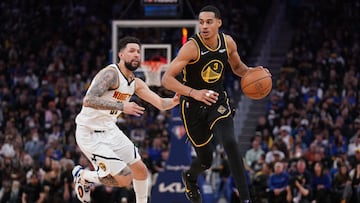 Jordan Poole (right) dribbles the ball against Denver Nuggets guard Austin Rivers. Mandatory Credit: Cary Edmondson-USA TODAY Sports