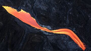 LA PALMA, SPAIN - NOVEMBER 13: Lava flows towards the sea under the Cumbre Vieja volcano as it continues to erupt on November 13, 2021 in La Palma, Spain. The volcano has been erupting since September 19, 2021 after weeks of seismic activity, resulting in