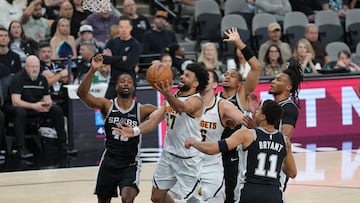 Denver Nuggets guard Jamal Murray (27) shoots in between San Antonio Spurs forwards Harrison Barnes (40) and forward Carter Bryant (11) in the first half at Frost Bank Center.