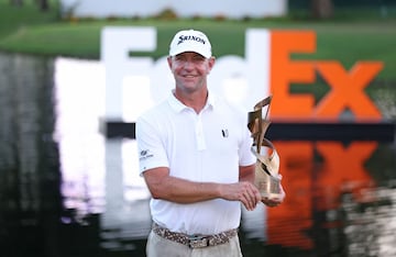 Lucas Glover of the United States poses with the trophy after putting in to win during the first playoff hole on the 18th green to win the tournament during the final round of the FedEx St. Jude Championship at TPC Southwind on August 13, 2023, in Memphis, Tennessee.