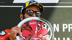 Italy&#039;s Danilo Petrucci holds his trophy as he celebrates on the podium after winning the Italian Moto GP Grand Prix at the Mugello race track on June 2, 2019 in Scarperia e San Piero. (Photo by Tiziana FABI / AFP)