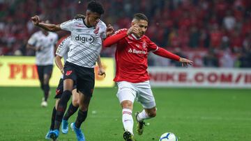 PORTO ALEGRE, BRAZIL - SEPTEMBER 18: Paolo Guerrero of Internacional battles for the ball against Robson Bambu of Athletico PR during the match between Internacional and Athletico PR as part of Copa do Brasil Final, at Beira-Rio Stadium on September 18, 2