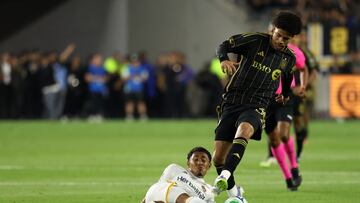 Jul 19, 2025; Los Angeles, California, USA; LA Galaxy defender Mauricio Cuevas (19) steals the ball from LAFC forward David Martinez (30) during the second half at BMO Stadium. Mandatory Credit: Kiyoshi Mio-Imagn Images