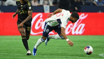 Nov 5, 2023; Vancouver, British Columbia, CAN; Vancouver Whitecaps midfielder Pedro Vite (45) falls while moving the ball against Los Angeles FC midfielder Kellyn Acosta (23) during the second half during the second half of game two in a round one match of the 2023 MLS Cup Playoffs at BC Place. Mandatory Credit: Anne-Marie Sorvin-USA TODAY Sports