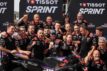 Aprilia Spanish rider Maverick Vinales (C) celebrates with teammates after winning the MotoGP sprint race of the Portuguese Grand Prix at the Algarve International Circuit in Portimao on March 23, 2024. (Photo by PATRICIA DE MELO MOREIRA / AFP)