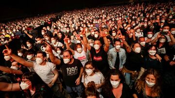 People wearing protective masks attend a concert of "Love of Lesbian" at the Palau Sant Jordi, the first massive concert since the beginning of the coronavirus disease (COVID-19) pandemic in Barcelona, Spain, March 27, 2021. REUTERS/Albert Gea TPX IMAGES OF THE DAY