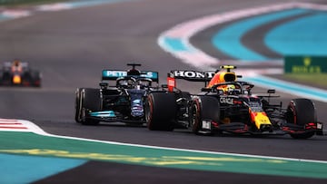 ABU DHABI, UNITED ARAB EMIRATES - DECEMBER 12: Sergio Perez of Mexico driving the (11) Red Bull Racing RB16B Honda leads Lewis Hamilton of Great Britain driving the (44) Mercedes AMG Petronas F1 Team Mercedes W12 with Max Verstappen of the Netherlands driving the (33) Red Bull Racing RB16B Honda in the distance behind during the F1 Grand Prix of Abu Dhabi at Yas Marina Circuit on December 12, 2021 in Abu Dhabi, United Arab Emirates. (Photo by Lars Baron/Getty Images)