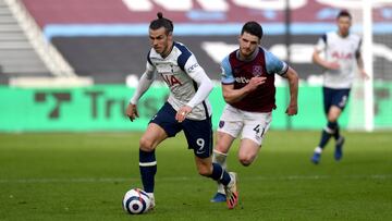 21 February 2021, United Kingdom, London: Tottenham Hotspur's Gareth Bale (L) and West Ham United's Declan Rice battle for the ball during the English Premier League soccer match between West Ham United and Tottenham Hotspur at the London Stadiu