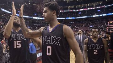 Phoenix Suns' Alan Williams, left, high-fives Marquese Chriss as they walk off court with Eric Bledsoe, right, following their victory over the Toronto Raptors in NBA basketball action in Toronto on Sunday, Jan. 22, 2017. (Chris Young/The Canadian Press via AP)