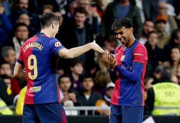 Soccer Football - LaLiga - Real Madrid v FC Barcelona - Santiago Bernabeu, Madrid, Spain - October 26, 2024 FC Barcelona's Lamine Yamal celebrates scoring their third goal with Robert Lewandowski REUTERS/Juan Medina