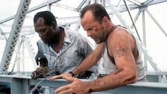 Samuel L Jackson and Bruce Willis standing on a bridge, looking down in a scene from the film 'Die Hard: With a Vengeance', 1995. (Photo by 20th Century-Fox/Getty Images)