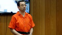 FILE PHOTO:    Larry Nassar, a former team USA Gymnastics doctor who pleaded guilty in November 2017 to sexual assault charges, stands in court during his sentencing hearing in the Eaton County Court in Charlotte, Michigan, U.S., February 5, 2018.  REUTER