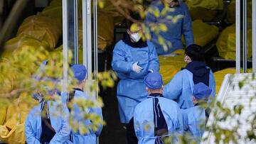 Staff members speak next to several body bags at a funeral home, as coronavirus disease (COVID-19) outbreaks continue in Shanghai, China, January 4, 2023. REUTERS/Staff