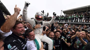 (FILES) In this file photo taken on November 11, 2018 Mercedes' British driver Lewis Hamilton celebrates after winning the F1 Brazil Grand Prix, while Mercedes took the constructors title, at the Interlagos racetrack in Sao Paulo, Brazil. (Photo by EVARISTO SA / AFP)
