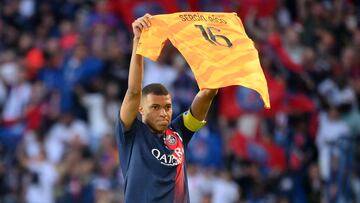 Paris Saint-Germain's French forward Kylian Mbappe celebrates scoring his team's second goal with holding up jersey of Paris Saint-Germain's Spanish goalkeeper Sergio Rico, who is in serious condition after a horse-riding accident, during the French L1 football match between Paris Saint-Germain (PSG) and Clermont Foot 63 at the Parc des Princes Stadium in Paris on June 3, 2023. (Photo by FRANCK FIFE / AFP)