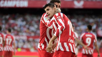 Atletico Madrid's Spanish midfielder Alvaro Morata (back) celebrates with teammate after scoring his team's second goal  during the Spanish League football match between Sevilla FC and Club Atletico de Madrid at the Ramon Sanchez Pizjuan stadium in Seville on October 1, 2022. (Photo by CRISTINA QUICLER / AFP) (Photo by CRISTINA QUICLER/AFP via Getty Images)