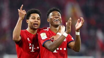 MUNICH, GERMANY - APRIL 06: Serge Gnabry of FC Bayern Muenchen and David Alaba of FC Bayern Muenchen celebrate after winning the Bundesliga match between FC Bayern Muenchen and Borussia Dortmund at Allianz Arena on April 6, 2019 in Munich, Germany. (Photo