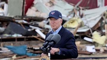 President Joe Biden looks on as he visits a neighborhood devastated by an outbreak of tornadoes that passed through several states, in Dawson Springs, Kentucky.