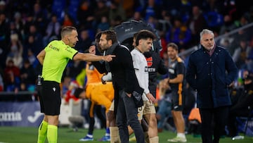 El colegiado Cuadra Fernández conversa con el técnico del Valencia, Rubén Baraja, durante el encuentro correspondiente a la jornada 16 de primera división que disputan hoy viernes Getafe y Valencia en el Coliseum de Getafe.