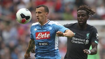 Liverpool's Divock Origi, right, with Napoli's Vlad Chiriches in action during their pre-season friendly soccer match at BT Murrayfield in Edinburgh, Scotland, Sunday July 28, 2019. (Jane Barlow/PA via AP)