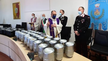 BERGAMO, ITALY - APRIL 10:  A Priest blesses 111 cinerary urns of the deceased from the COVID-19 Pandemic in the hall of the municipal house of Ponte San Pietro, before being delivered to family members Italy. There have been well over 100,000 reported CO