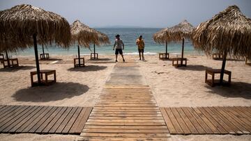 FILE PHOTO: Workers install wooden corridors on a beach, a day before the official opening of beaches to the public following the easing of measures against the spread of the coronavirus disease (COVID-19), in Athens, Greece, May 15, 2020. REUTERS/Alkis Konstantinidis/File Photo